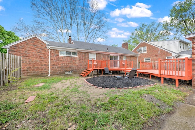 839 E Hayes Ave, Hazel Park, MI 48030 - rear view of house featuring brick siding, a wooden deck, fence, and a chimney