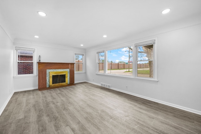 839 E Hayes Ave, Hazel Park, MI 48030 - unfurnished living room featuring baseboards, recessed lighting, a fireplace, and wood finished floors