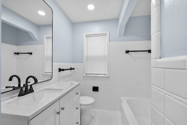 839 E Hayes Ave, Hazel Park, MI 48030 - full bathroom with tile walls, a wainscoted wall, toilet, a tub to relax in, and vanity