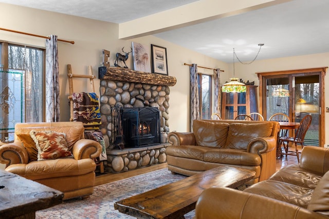 living room featuring wood finished floors and a stone fireplace