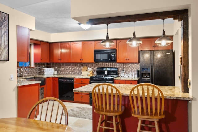 kitchen with black appliances, a sink, decorative backsplash, and a peninsula