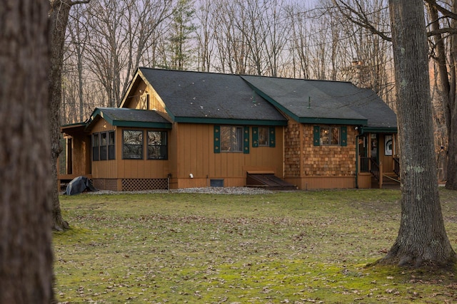 rustic home with a front yard and roof with shingles
