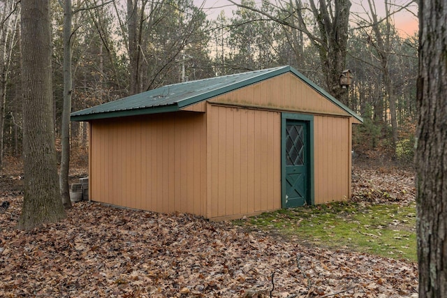 view of outbuilding with an outbuilding and a wooded view