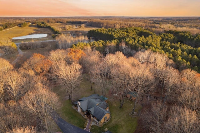 view of subject property with a heavily wooded area