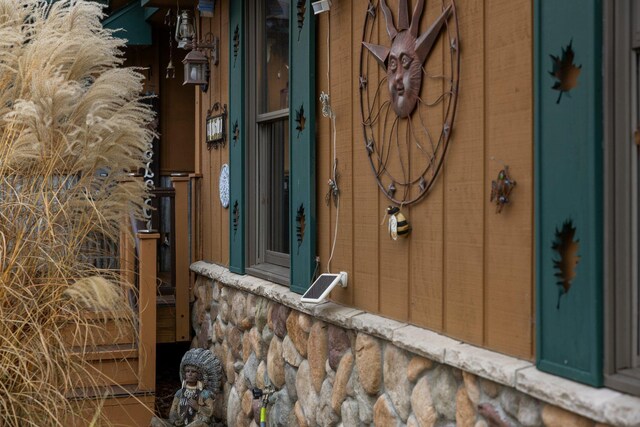 view of property exterior with stone siding