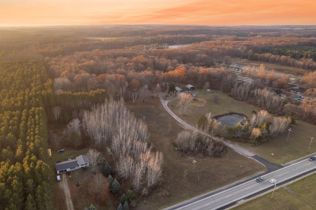 aerial view of property's location featuring a heavily wooded area