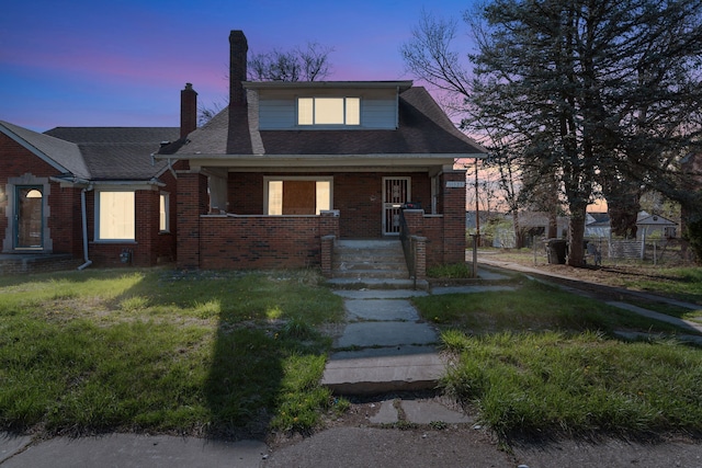 11323 Bramell, Redford, MI 48239 - bungalow-style home featuring a chimney, brick siding, a porch, and a front yard