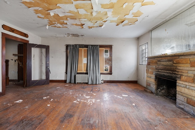 11323 Bramell, Redford, MI 48239 - unfurnished living room with hardwood / wood-style floors, a stone fireplace, and radiator