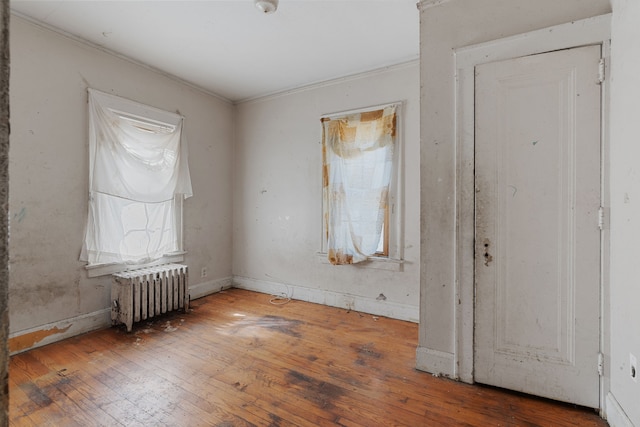 11323 Bramell, Redford, MI 48239 - spare room featuring radiator, wood-type flooring, and crown molding