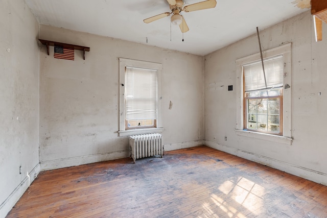 11323 Bramell, Redford, MI 48239 - spare room featuring radiator, hardwood / wood-style floors, healthy amount of natural light, and a ceiling fan
