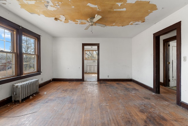 11323 Bramell, Redford, MI 48239 - unfurnished room with radiator heating unit, hardwood / wood-style floors, a ceiling fan, and baseboards