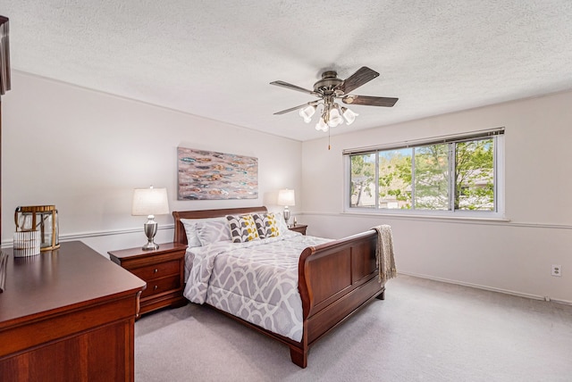 carpeted bedroom with a textured ceiling and ceiling fan