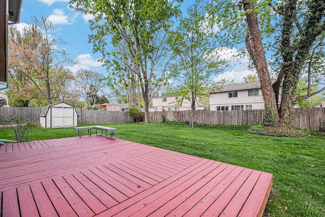 wooden deck featuring a shed and an outdoor structure