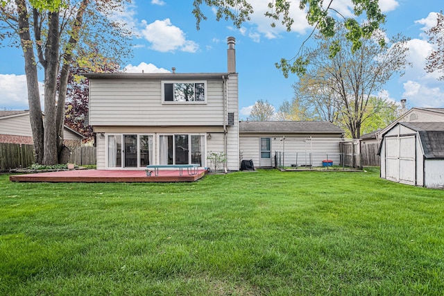 rear view of property with a storage shed, a wooden deck, an outdoor structure, and a chimney