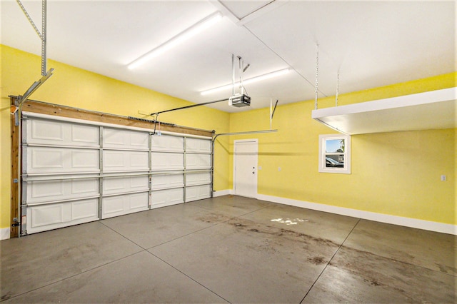 13780 Alaska Ave, Eagle, MI 48822 - garage featuring baseboards and a garage door opener