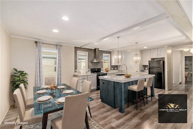 13780 Alaska Ave, Eagle, MI 48822 - dining space with light wood-style flooring, recessed lighting, ornamental molding, and beam ceiling