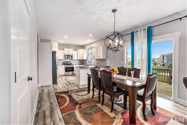 6526 Alward Dr, Hudsonville, MI 49426 - dining space with light wood-style flooring, a chandelier, and recessed lighting