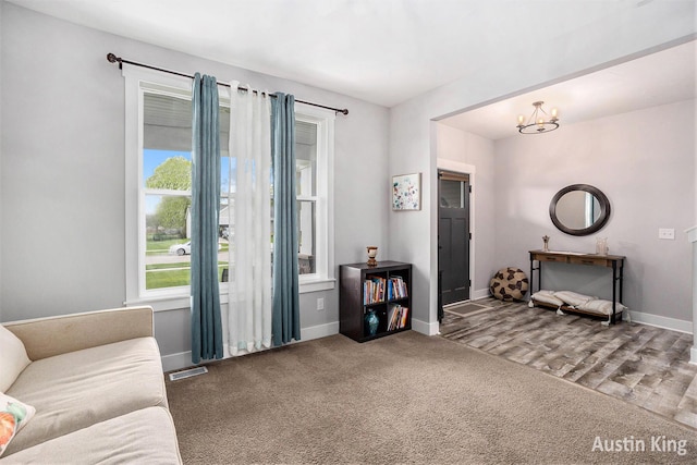 6526 Alward Dr, Hudsonville, MI 49426 - living room with baseboards, carpet flooring, and a chandelier
