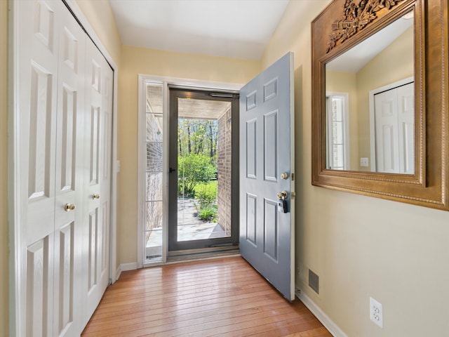 entrance foyer with light wood finished floors and baseboards