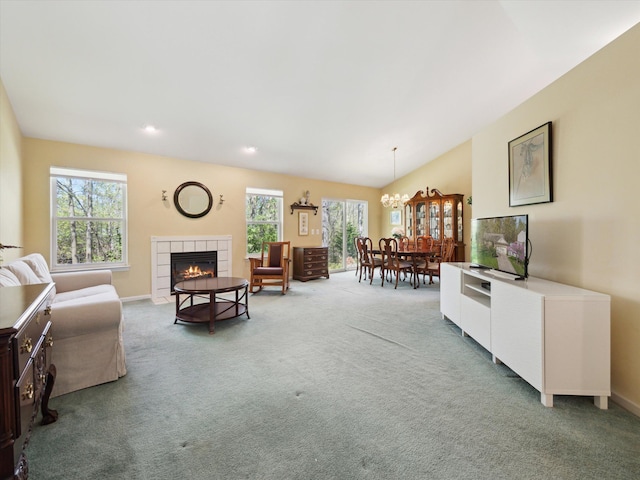 carpeted living room featuring a tiled fireplace, a chandelier, baseboards, recessed lighting, and lofted ceiling