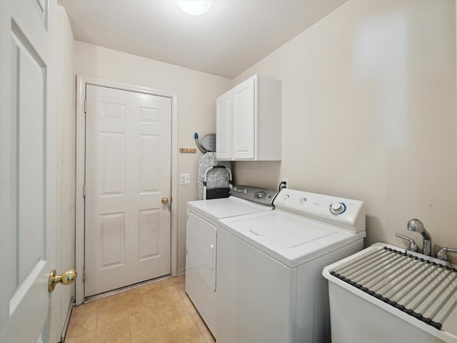 laundry area with washer and dryer, cabinet space, and light tile patterned floors