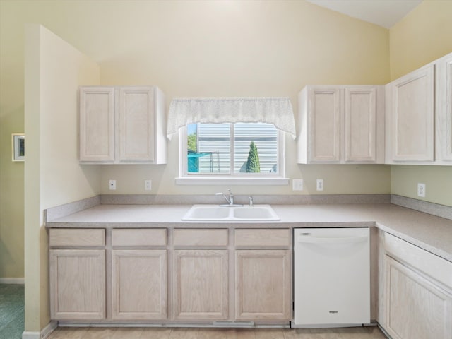 kitchen with white dishwasher, a sink, light countertops, and light brown cabinets