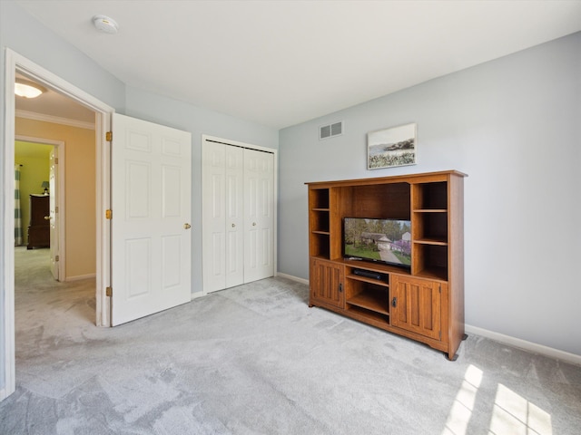 unfurnished living room with carpet and baseboards