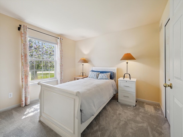 bedroom with light colored carpet and baseboards