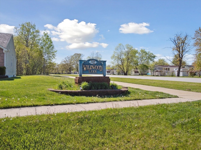 community sign featuring a lawn