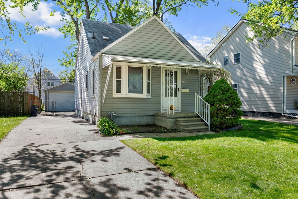 view of front of home with an outbuilding, a garage, and a porch