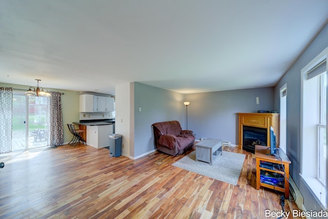 823 Warner St, Whitehall, MI 49461 - living room with light wood-style floors, a fireplace, and baseboards