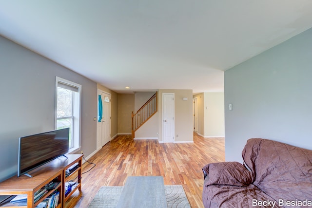 823 Warner St, Whitehall, MI 49461 - living room with stairway, light wood-style flooring, and baseboards