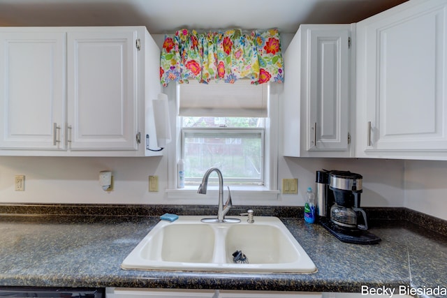 823 Warner St, Whitehall, MI 49461 - kitchen with a sink, dark countertops, and white cabinets