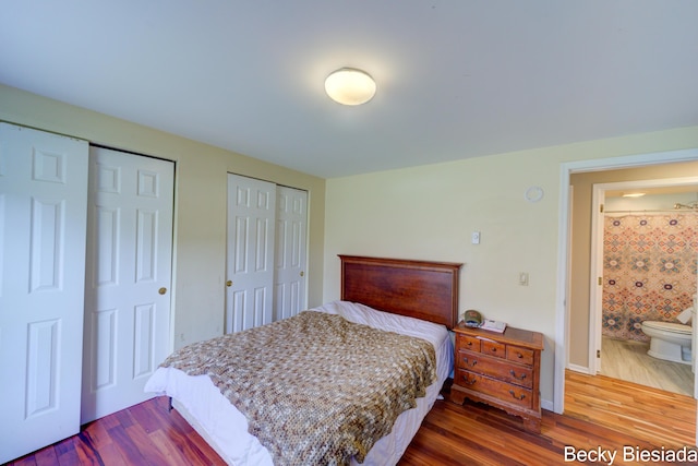 823 Warner St, Whitehall, MI 49461 - bedroom featuring two closets, dark wood-style floors, and baseboards