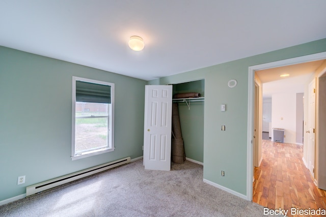 823 Warner St, Whitehall, MI 49461 - unfurnished bedroom with a baseboard heating unit, a closet, and baseboards