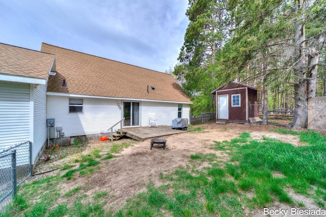 823 Warner St, Whitehall, MI 49461 - back of property with a fenced backyard, a wooden deck, a shed, and an outbuilding