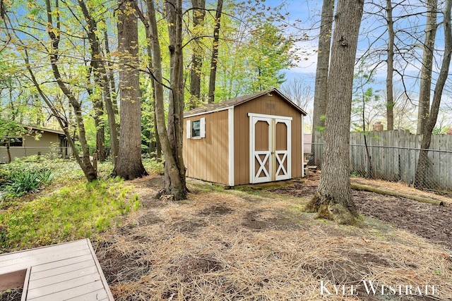 view of shed featuring fence