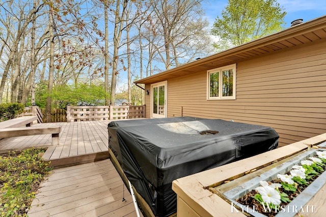 deck with a jacuzzi and a grill