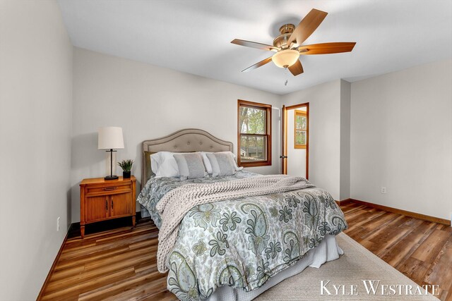bedroom with wood finished floors, baseboards, and ceiling fan