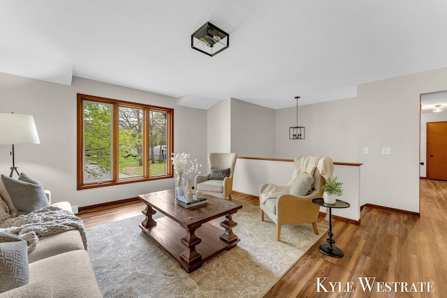 living area featuring wood finished floors and baseboards