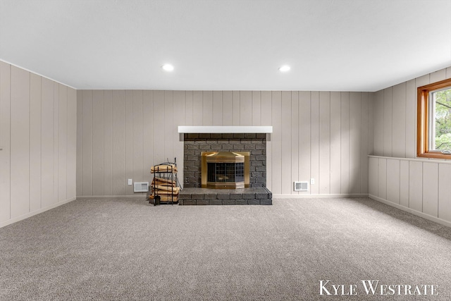 unfurnished living room with a fireplace, carpet flooring, and recessed lighting