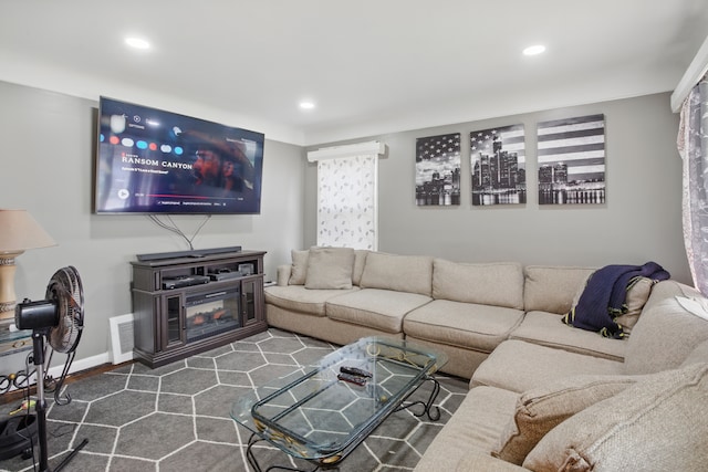 living room with recessed lighting and baseboards