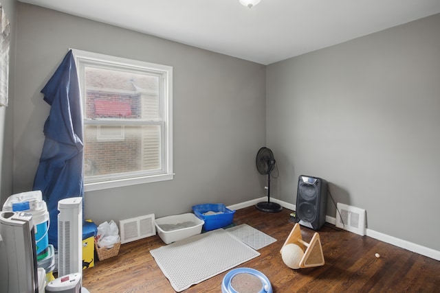 miscellaneous room featuring wood finished floors and baseboards