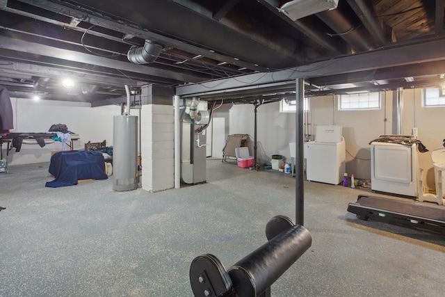 basement featuring gas water heater, washing machine and dryer, and heating unit