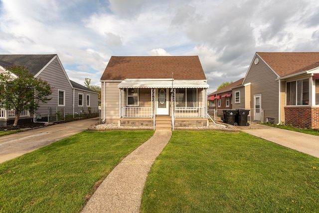 cape cod home featuring a front lawn, a porch, and a shingled roof