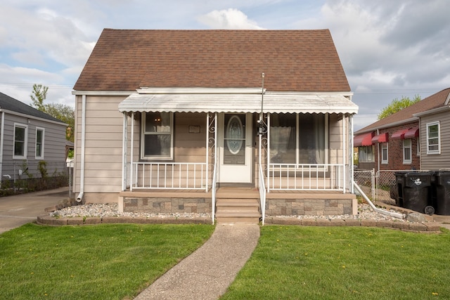 view of front of house featuring roof with shingles and covered porch