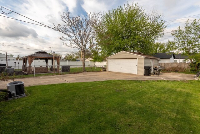 view of yard featuring central AC unit, an outdoor structure, a gazebo, and a detached garage