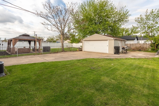 view of yard with an outbuilding, a garage, and a gazebo