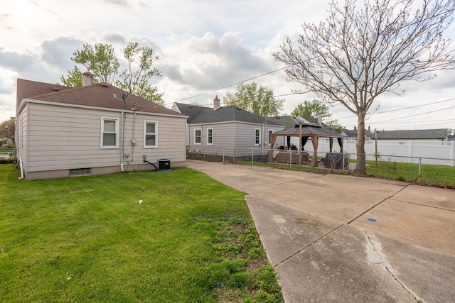 back of house featuring a gazebo, central AC, concrete driveway, a shingled roof, and a patio