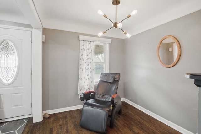 entryway featuring a chandelier, wood finished floors, and baseboards
